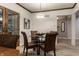 Cozy dining area with glass top table, wicker chairs, light fixture, and french doors to the outside at 8905 Washington Blvd West Dr, Indianapolis, IN 46240