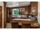 Charming kitchen with wooden cabinets, modern lighting, and a cozy breakfast nook area at 8905 Washington Blvd West Dr, Indianapolis, IN 46240