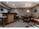 Finished basement with a bar area, table, and cozy chairs under recessed lighting at 8905 Washington Blvd West Dr, Indianapolis, IN 46240