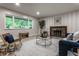 Inviting living room featuring vinyl floors, a fireplace, and a large window with green views at 8905 Washington Blvd West Dr, Indianapolis, IN 46240