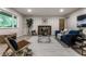 Inviting living room featuring vinyl floors, a fireplace, and a large window with green views at 8905 Washington Blvd West Dr, Indianapolis, IN 46240