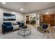 Open-concept living room featuring vinyl floors, a fireplace, and an open dining area at 8905 Washington Blvd West Dr, Indianapolis, IN 46240