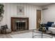 Inviting living room featuring vinyl floors, a fireplace, and a plush blue couch at 8905 Washington Blvd West Dr, Indianapolis, IN 46240