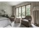 Tranquil bedroom featuring a sitting area by the window and neutral decor for a serene space at 8905 Washington Blvd West Dr, Indianapolis, IN 46240