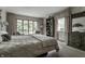 Relaxing main bedroom with carpet, an upholstered bed, and large windows with seating area to enjoy the view at 8905 Washington Blvd West Dr, Indianapolis, IN 46240