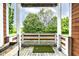 Cozy balcony with wood flooring and a view of lush greenery, perfect for relaxing outdoors at 902 Woodlawn Ave, Indianapolis, IN 46203