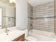 Modern bathroom with updated tile, fixtures, and a combined tub and shower at 902 Woodlawn Ave, Indianapolis, IN 46203
