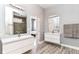 Dual vanities in a modern bathroom with two mirrors and an adjoining bedroom doorway at 902 Woodlawn Ave, Indianapolis, IN 46203
