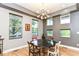 Bright dining area with hardwood floors, stylish lighting, and a view of the outdoor greenery at 902 Woodlawn Ave, Indianapolis, IN 46203
