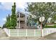 Charming two-story townhouse featuring modern accents and a classic white picket fence at 902 Woodlawn Ave, Indianapolis, IN 46203