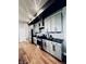 Modern kitchen with stainless steel appliances, subway tile backsplash, and black countertops at 902 Woodlawn Ave, Indianapolis, IN 46203