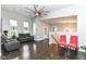 Bright open-plan living room with hardwood floors and large windows, connecting to the entryway at 902 Woodlawn Ave, Indianapolis, IN 46203