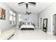 Serene main bedroom boasts a large window, neutral decor, and a ceiling fan at 902 Woodlawn Ave, Indianapolis, IN 46203