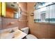Bathroom with a vanity, toilet, window, and bright wallpaper at 924 N Devon Ave, Indianapolis, IN 46219