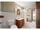Cozy bathroom featuring a tub and shower combination, sink with storage, and tiled flooring at 924 N Devon Ave, Indianapolis, IN 46219