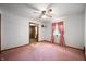 Bedroom with pink carpet and walls and a ceiling fan at 924 N Devon Ave, Indianapolis, IN 46219