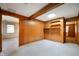 Bonus room featuring wood paneled walls, skylight, carpet and two entrances at 924 N Devon Ave, Indianapolis, IN 46219