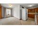 Open dining area with neutral carpet, white walls, and a bright window at 924 N Devon Ave, Indianapolis, IN 46219