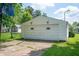 Detached garage with a paved driveway, set against a backdrop of lush greenery at 924 N Devon Ave, Indianapolis, IN 46219
