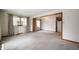 Spacious living room with neutral walls, large windows, and view into another living area at 924 N Devon Ave, Indianapolis, IN 46219