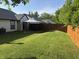 Lush backyard with green grass, patio area, wooden fence, and cozy gazebo at 9507 Colony Pointe E Dr, Indianapolis, IN 46250