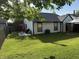 Well-maintained backyard with a green lawn, patio, and partial privacy fence at 9507 Colony Pointe E Dr, Indianapolis, IN 46250