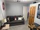 Finished basement area perfect for entertainment, featuring a comfortable sofa and projector at 9507 Colony Pointe E Dr, Indianapolis, IN 46250