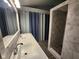 Stylish bathroom with a double sink vanity, modern tiling, and a glass-enclosed shower at 9507 Colony Pointe E Dr, Indianapolis, IN 46250