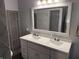 Updated bathroom featuring a double vanity, modern fixtures, and a tiled shower at 9507 Colony Pointe E Dr, Indianapolis, IN 46250