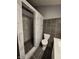 Modern bathroom featuring a walk-in shower with hexagon-shaped tile and updated fixtures at 9507 Colony Pointe E Dr, Indianapolis, IN 46250