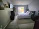 Cozy bedroom with sliding glass doors to patio, gray walls, and neutral carpet at 9507 Colony Pointe E Dr, Indianapolis, IN 46250