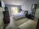Comfortable bedroom with plush carpet and patio access, bathed in natural light at 9507 Colony Pointe E Dr, Indianapolis, IN 46250