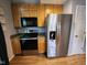 Efficient kitchen with stainless steel appliances, wood cabinets, and a sleek microwave setup at 9507 Colony Pointe E Dr, Indianapolis, IN 46250