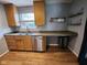 Bright kitchen featuring wood cabinets, a stainless steel dishwasher, and a stylish countertop at 9507 Colony Pointe E Dr, Indianapolis, IN 46250