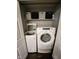 Convenient laundry closet with modern, stacked washer and dryer, and additional storage shelf at 9507 Colony Pointe E Dr, Indianapolis, IN 46250