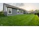 Backyard view showing the well-manicured lawn and the exterior of a house with tasteful siding at 9741 Haughton Ln, McCordsville, IN 46055