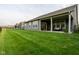 Lush backyard featuring a covered patio, iron fence, and expansive green lawn at 9741 Haughton Ln, McCordsville, IN 46055