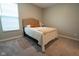 Neutral bedroom featuring tan upholstered headboard, soft throw blanket, and a bright window at 9741 Haughton Ln, McCordsville, IN 46055