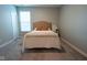 Neutral bedroom featuring tan upholstered headboard, soft throw blanket, and a window for natural light at 9741 Haughton Ln, McCordsville, IN 46055