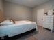 Neutral bedroom featuring tan upholstered headboard, soft throw blanket, and a bright white dresser at 9741 Haughton Ln, McCordsville, IN 46055