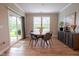 Bright dining room features a modern round table and chairs, wood floors, and sliding glass doors to the outside at 9741 Haughton Ln, McCordsville, IN 46055