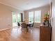 Cozy dining area with natural light, a round table, and access to the outdoor patio through sliding glass doors at 9741 Haughton Ln, McCordsville, IN 46055