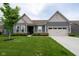 Charming single-story home featuring a well-manicured lawn, inviting curb appeal, and a two-car garage at 9741 Haughton Ln, McCordsville, IN 46055