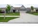 Beautiful single-story home with a long concrete driveway and a well-maintained front lawn at 9741 Haughton Ln, McCordsville, IN 46055