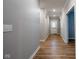 Inviting entryway featuring sleek wood floors, neutral paint, and classic white trim at 9741 Haughton Ln, McCordsville, IN 46055