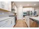 Bright kitchen featuring white cabinetry, stainless steel appliances, and a stylish range hood at 9741 Haughton Ln, McCordsville, IN 46055