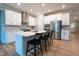 Modern kitchen showcasing white cabinets, a center island with bar stools, and stainless steel appliances at 9741 Haughton Ln, McCordsville, IN 46055