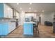 Bright, open kitchen features white cabinets, stainless steel appliances, and a large island with seating at 9741 Haughton Ln, McCordsville, IN 46055