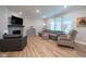 Cozy living room with fireplace, comfortable seating, and plenty of natural light creating a warm ambiance at 9741 Haughton Ln, McCordsville, IN 46055