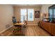 Bright home office space with wood floors, natural light, and a modern desk and chair at 9741 Haughton Ln, McCordsville, IN 46055